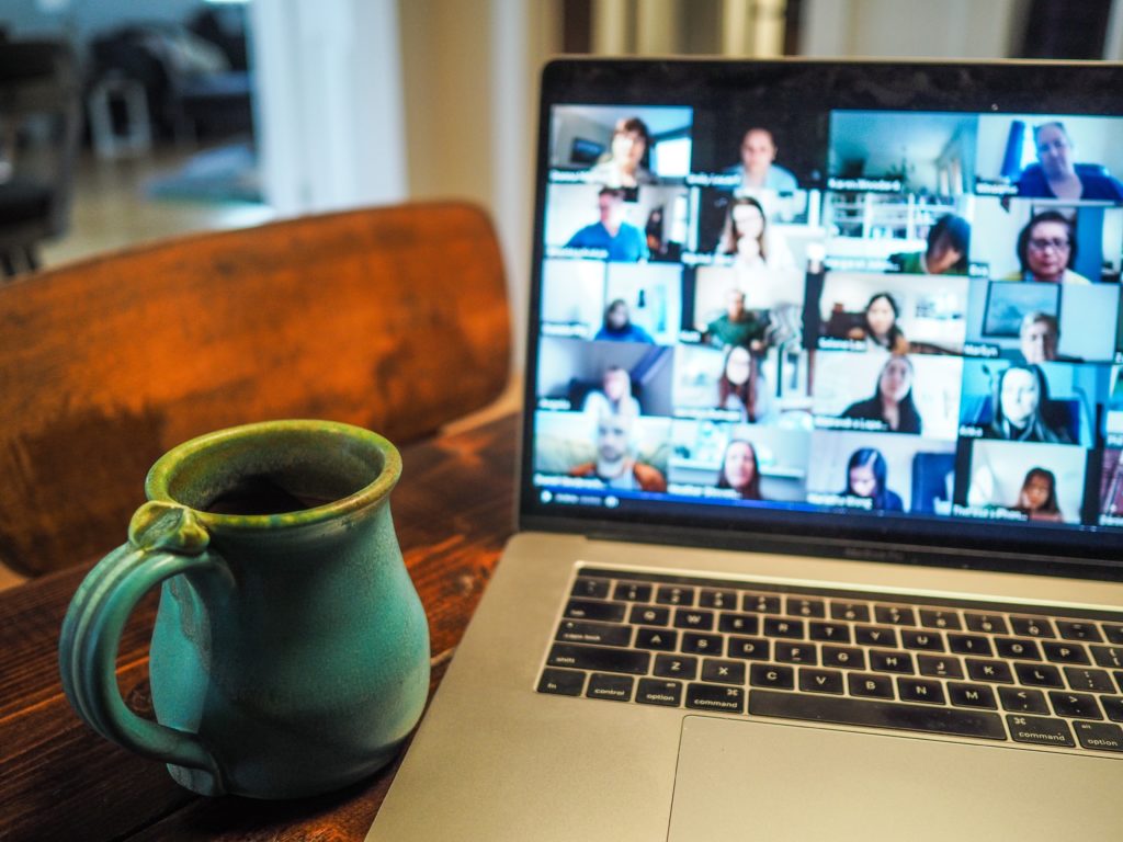 Image displays zoom or video meeting taking place.